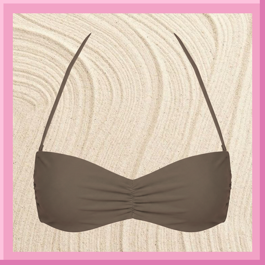 Brown bikini top on a textured beige background with a pink border
