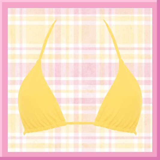 Yellow bikini top on a pink and white plaid background