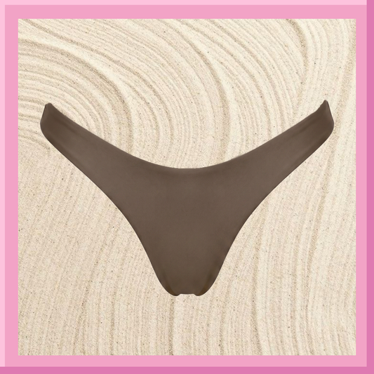 Brown bikini bottoms on textured sand background with pink border